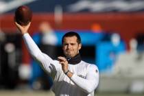 Raiders quarterback Derek Carr warms up before the start of an NFL football game against the De ...