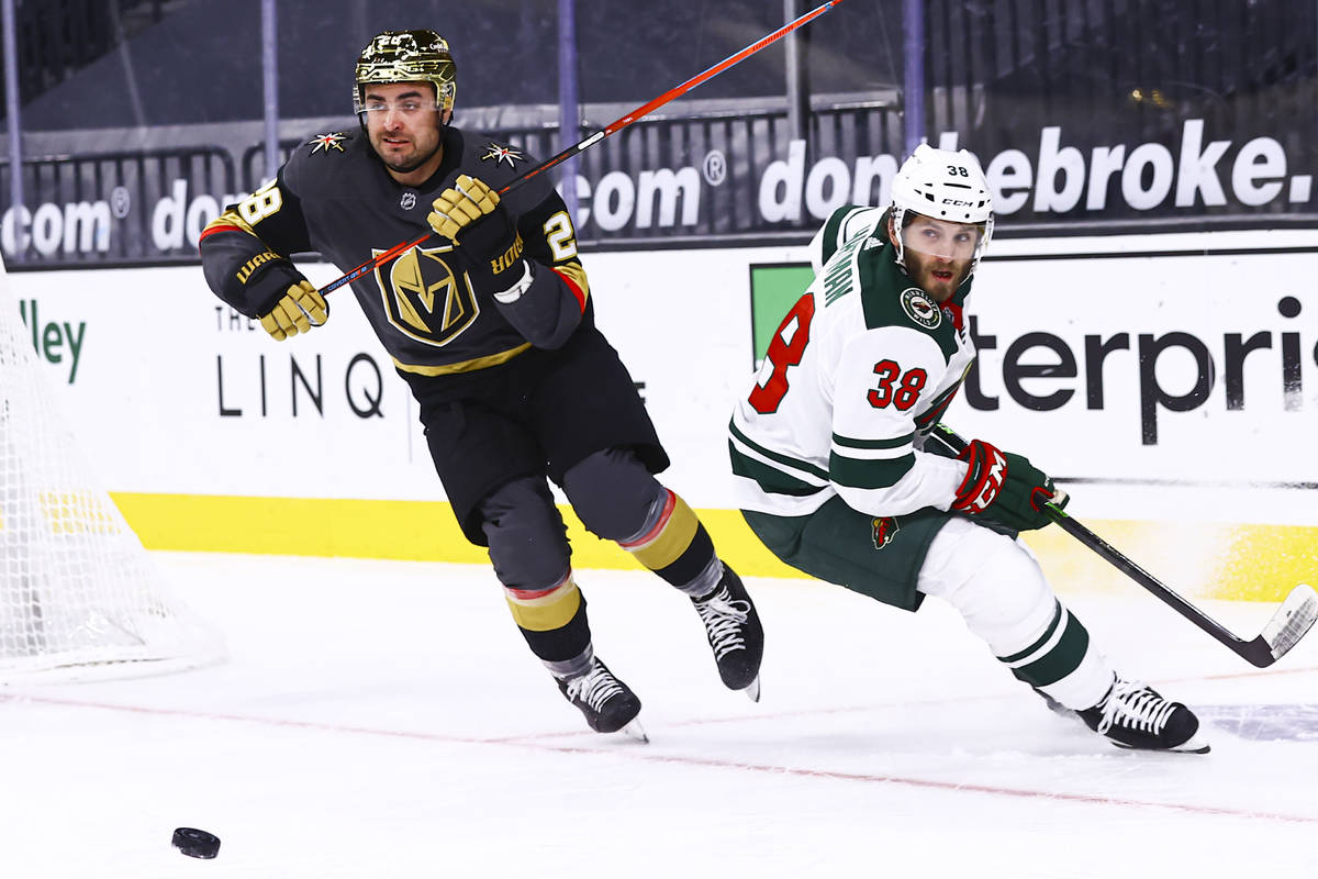 Golden Knights left wing William Carrier (28) gets the puck around Minnesota Wild right wing Ry ...