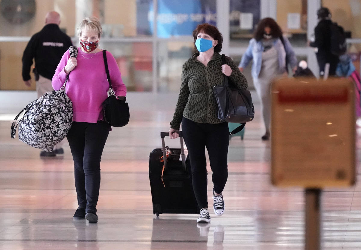 To prevent the spread of Covid-19, travelers wear masks at Love Field Tuesday, March 2, 2021, i ...