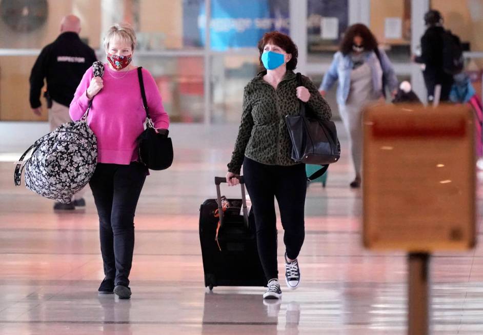 To prevent the spread of Covid-19, travelers wear masks at Love Field Tuesday, March 2, 2021, i ...