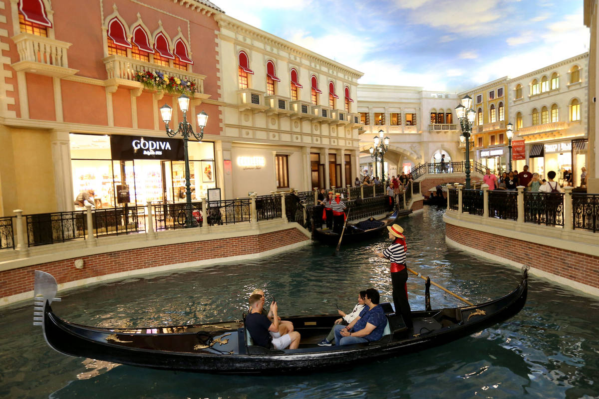 Guests take a gondola ride in the Grand Canal at The Venetian on the Strip in Las Vegas Tuesday ...