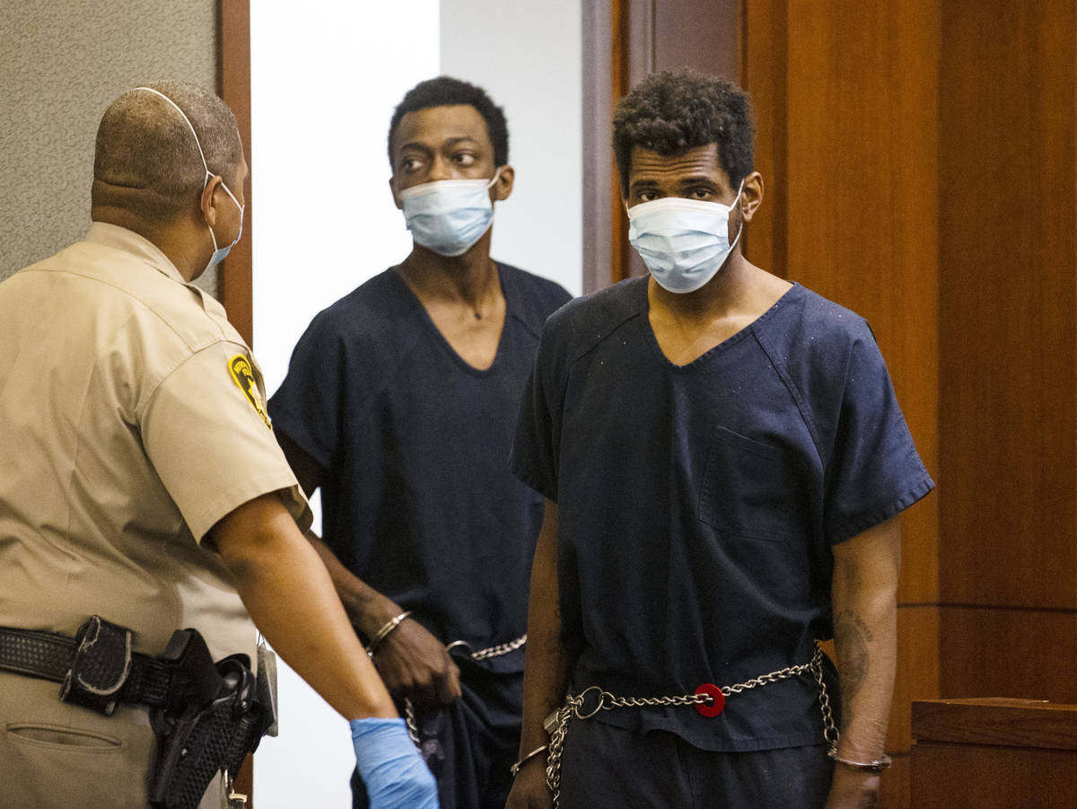 Brandon Leath, right, accused of punching and killing a man outside Bally's, is led into the co ...