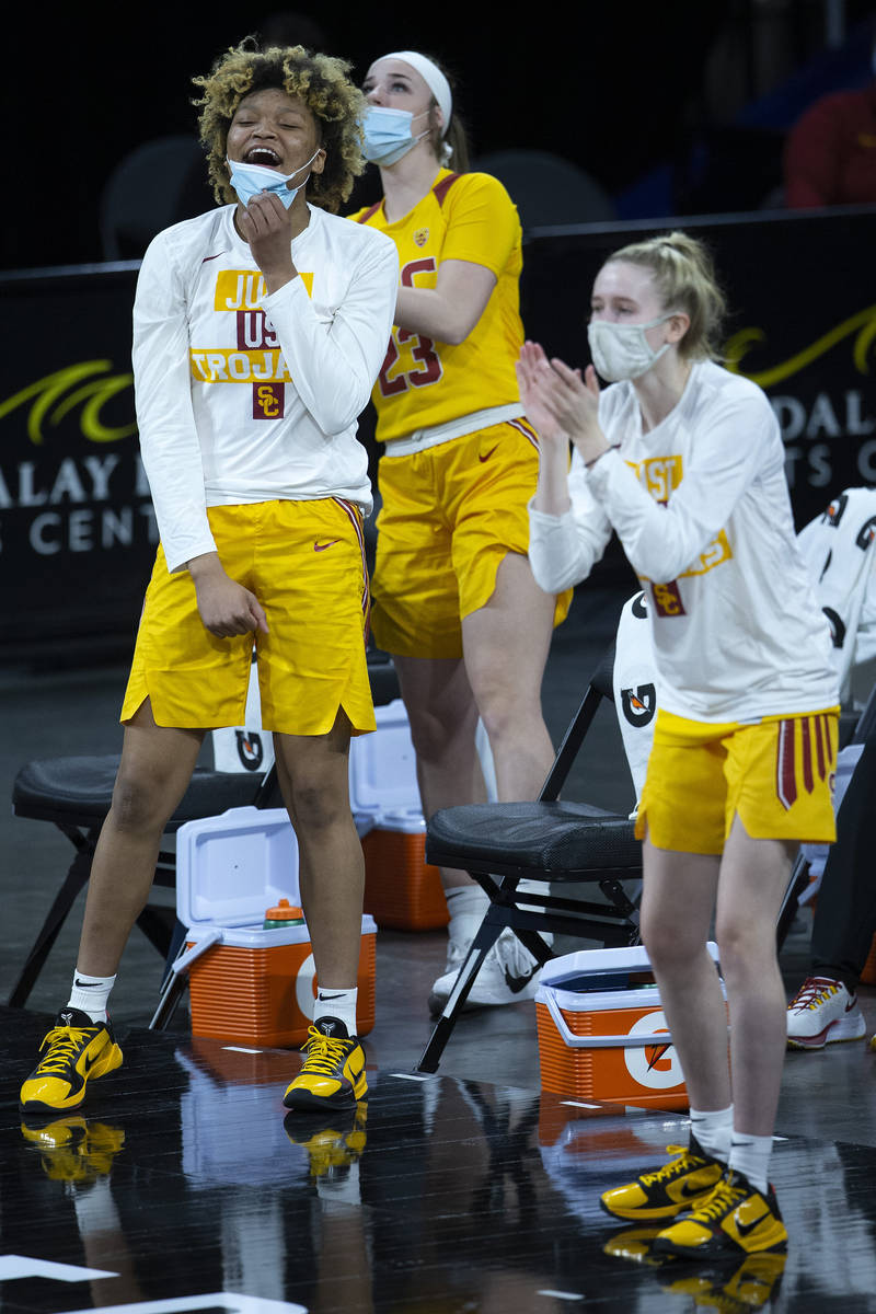 USC Trojans guard Amaya Oliver (10), guard Madison Campbell (23) and guard India Otto (2) cheer ...