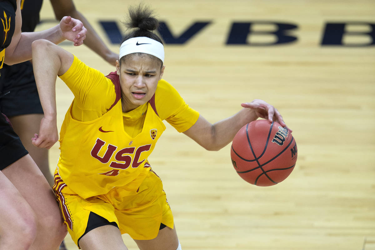 USC Trojans guard Endyia Rogers (4) dribbles around Arizona State Sun Devils guard Maggie Besse ...