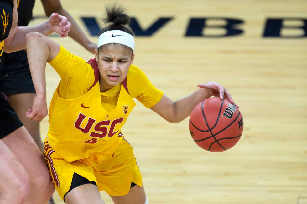 USC Trojans guard Endyia Rogers (4) dribbles around Arizona State Sun Devils guard Maggie Besse ...