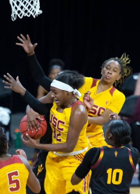 USC Trojans forward Jordyn Jenkins (32) and USC Trojans guard Shalexxus Aaron (0) jump to block ...