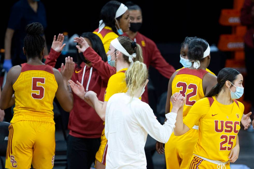 USC Trojans guard Alyson Miura (25) and guard India Otto (2) high five after winning their NCAA ...