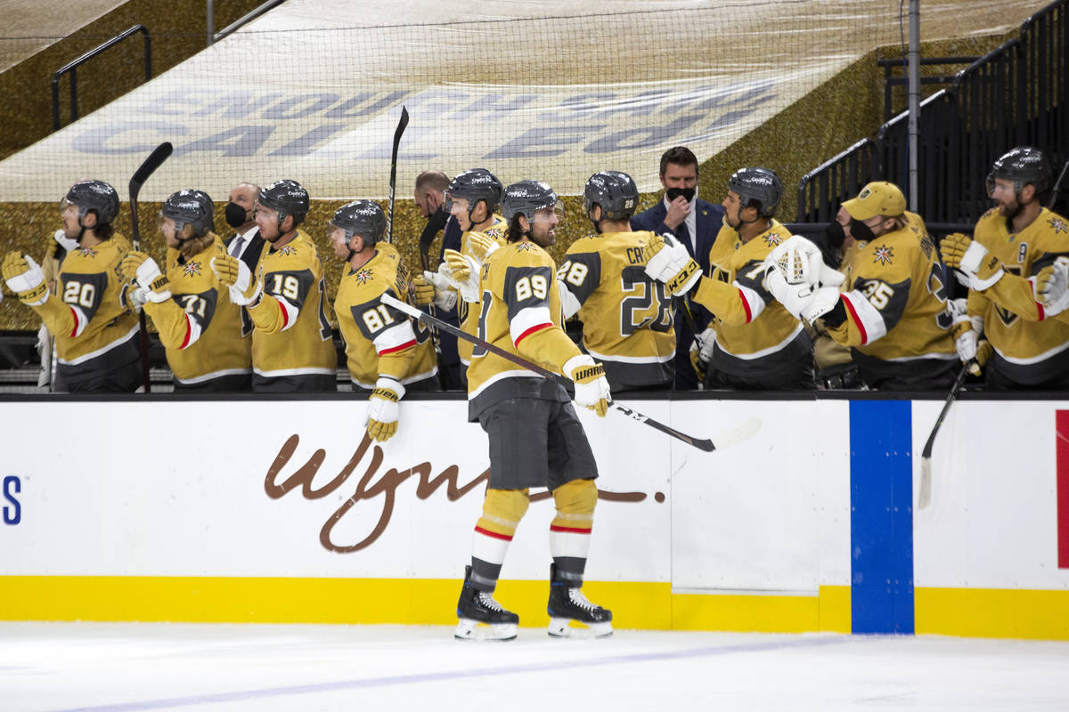 Golden Knights right wing Alex Tuch (89) is congratulated by the team after scoring the first g ...