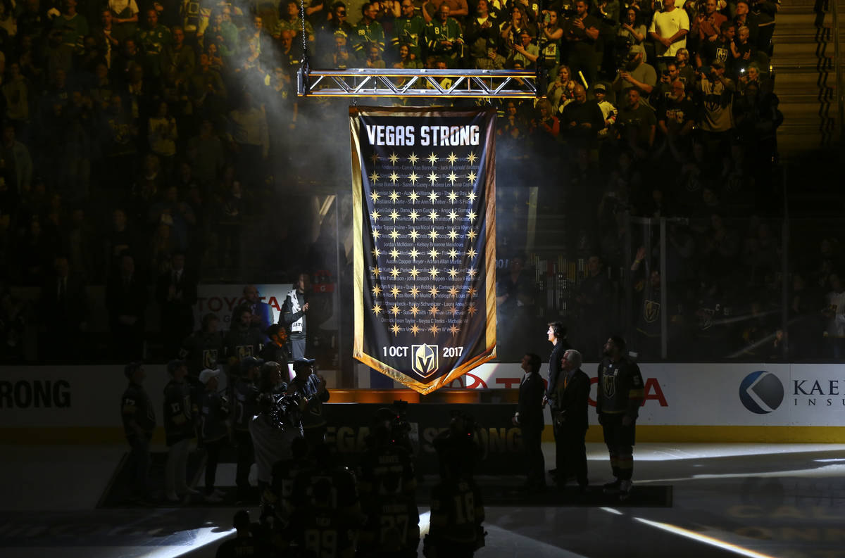 A banner is raised in honor of the victims of the shooting before the start of an NHL hockey ga ...