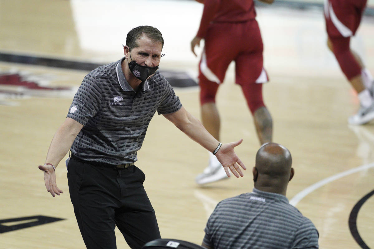 Arkansas head coach Eric Musselman communicates with players and coaches on the bench during th ...