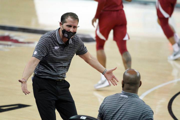 Arkansas head coach Eric Musselman communicates with players and coaches on the bench during th ...