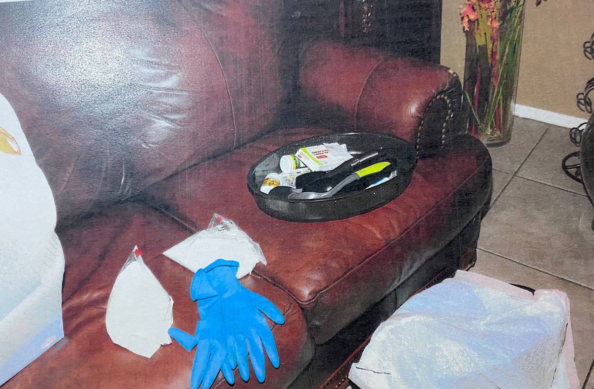 An evidence photo shows rubber gloves on a couch inside the home of Jose Rangel and his son Eri ...