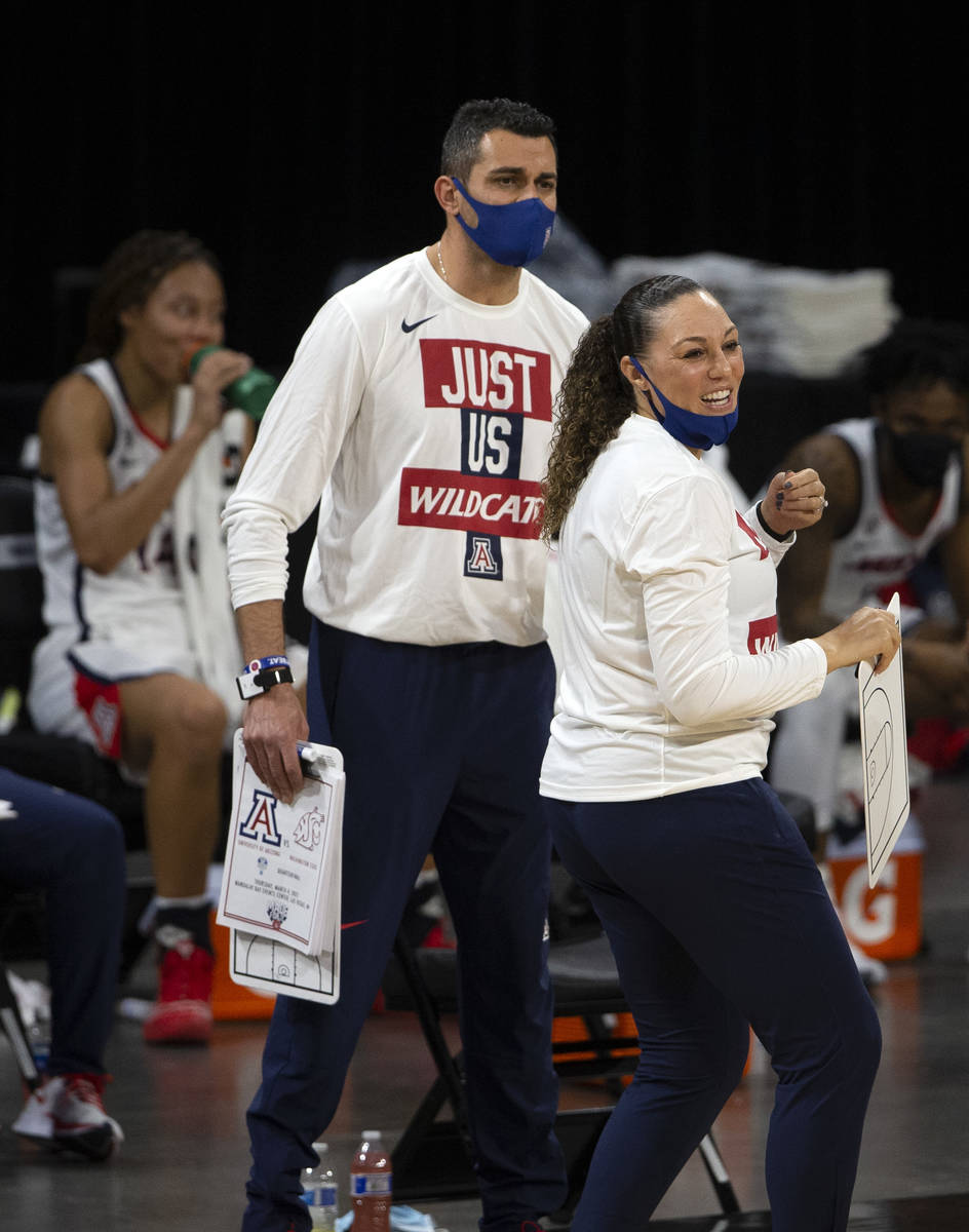 Arizona Wildcats head coach Adia Barnes and assistant coach Salvo Coppa react to their team sco ...