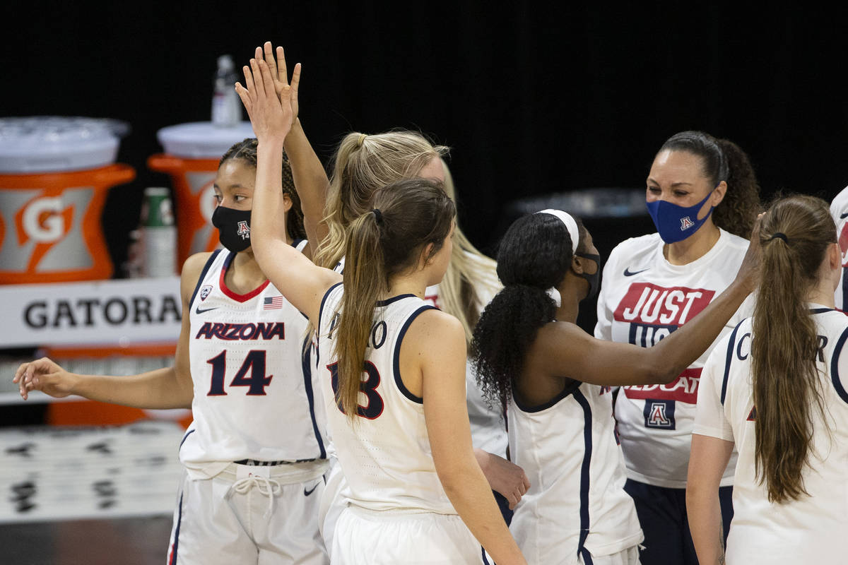 Arizona Wildcats forward Sam Thomas (14) and guard Helena Pueyo (13) high five while head coach ...