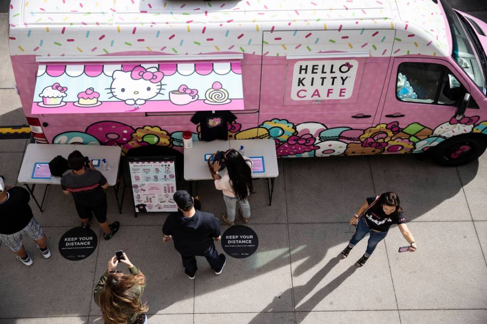 Kaye Anderson of Las Vegas, right, takes a photos in front of the Hello Kitty Cafe truck at Dow ...