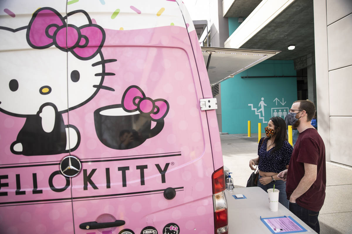 Nicole Muñoz, left, and her boyfriend Chris Starr shop at the Hello Kitty Cafe truck at Do ...