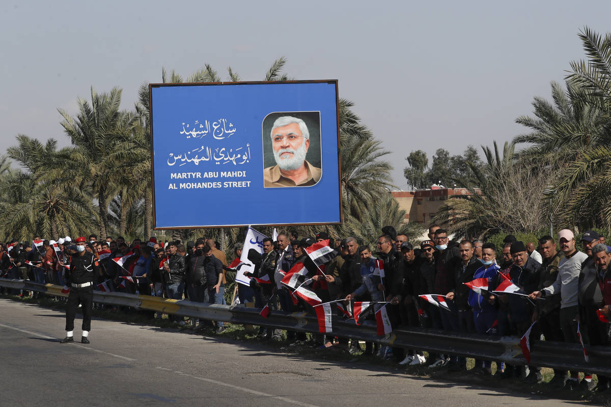 Peoplestand by the road as they wait for Pope Francis to pass by, in Baghdad Iraq, Friday, Marc ...
