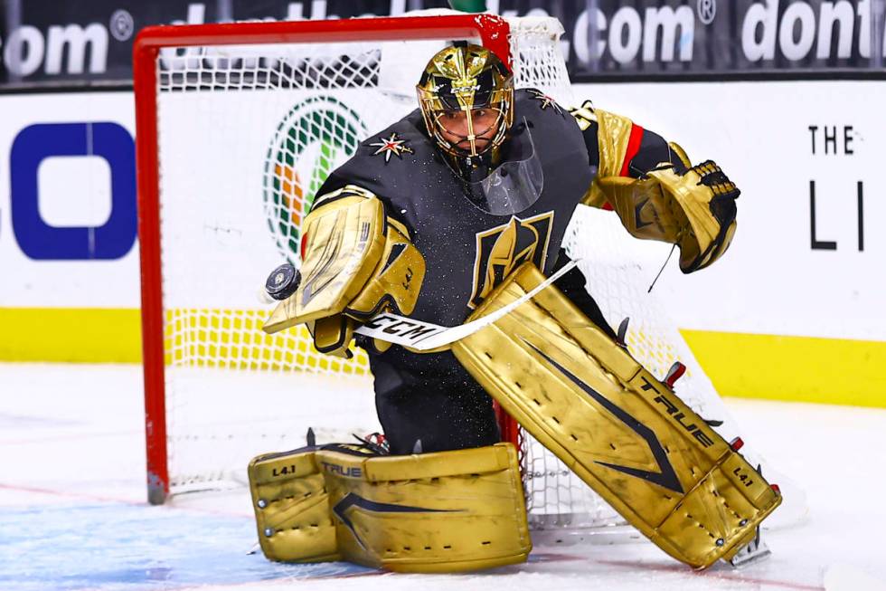 Golden Knights goaltender Marc-Andre Fleury (29) blocks the puck during the first period of an ...