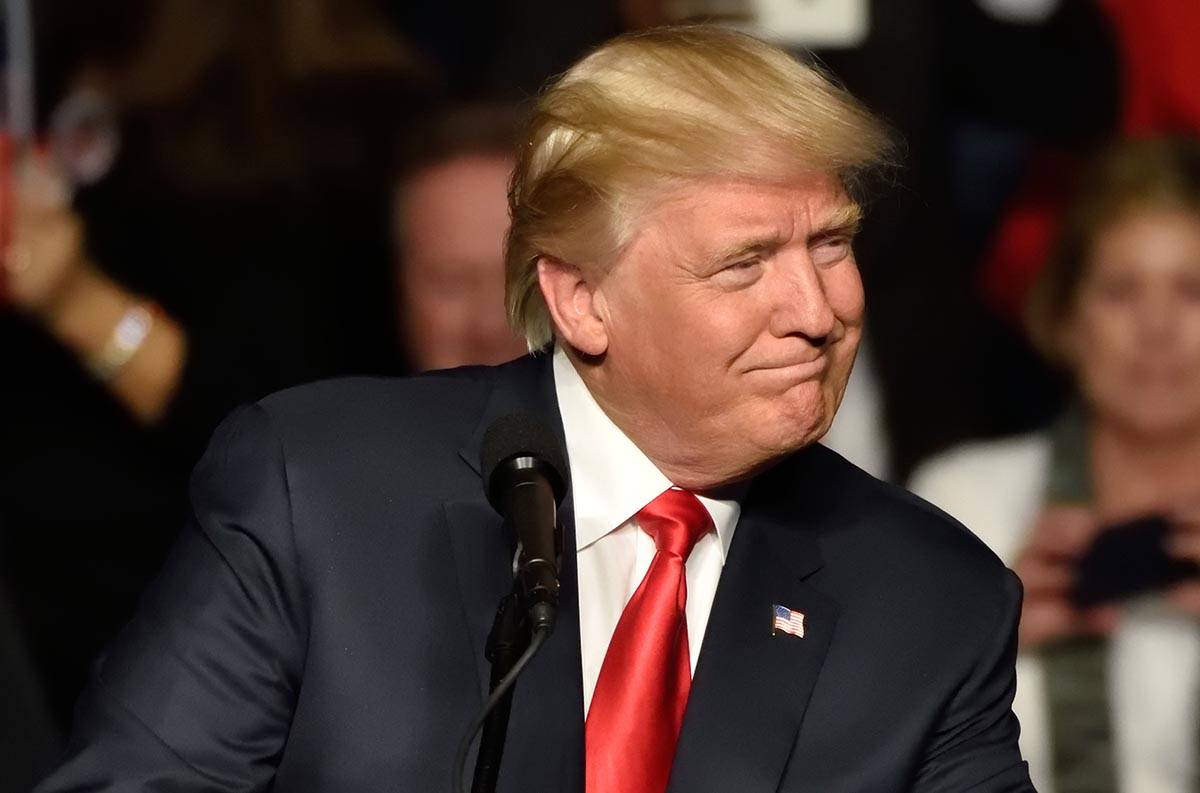 Then president-elect Donald Trump looks left toward the crowd as he delivers a speech at a "Tha ...