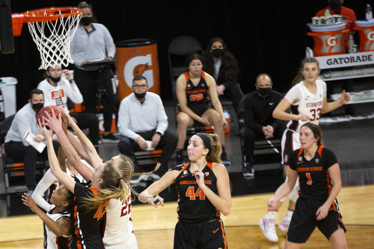 Stanford Cardinal guard Kiana Williams (23) and forward Cameron Brink (22) compete for the ball ...