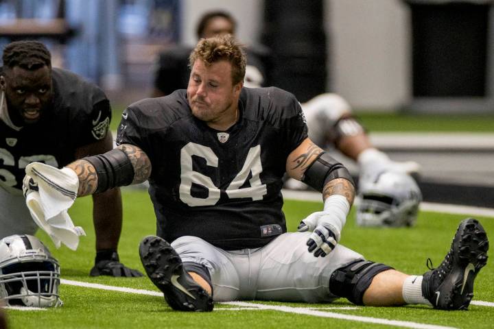 Las Vegas Raiders guard Richie Incognito (64) stretches with teammates during warm ups at the I ...