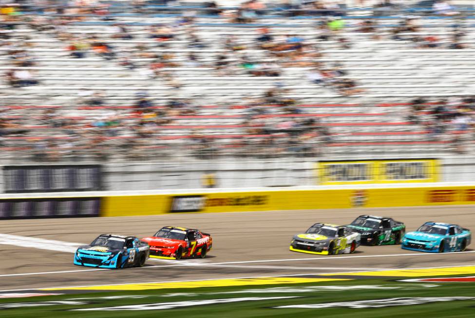 Drivers pass the start/finish line during a NASCAR Xfinity Series auto race at the Las Vegas Mo ...