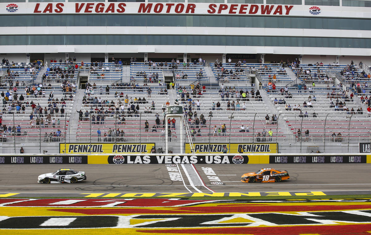 AJ Allmendinger (16) maintains a lead over Daniel Hemric (18) in the final laps of a NASCAR Xfi ...