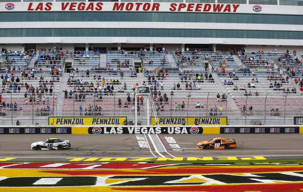 AJ Allmendinger (16) maintains a lead over Daniel Hemric (18) in the final laps of a NASCAR Xfi ...