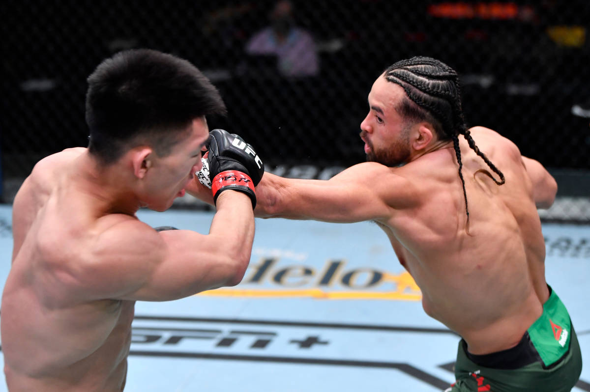 LAS VEGAS, NEVADA - MARCH 06: (R-L) Kyler Phillips punches Song Yadong of China in their bantam ...