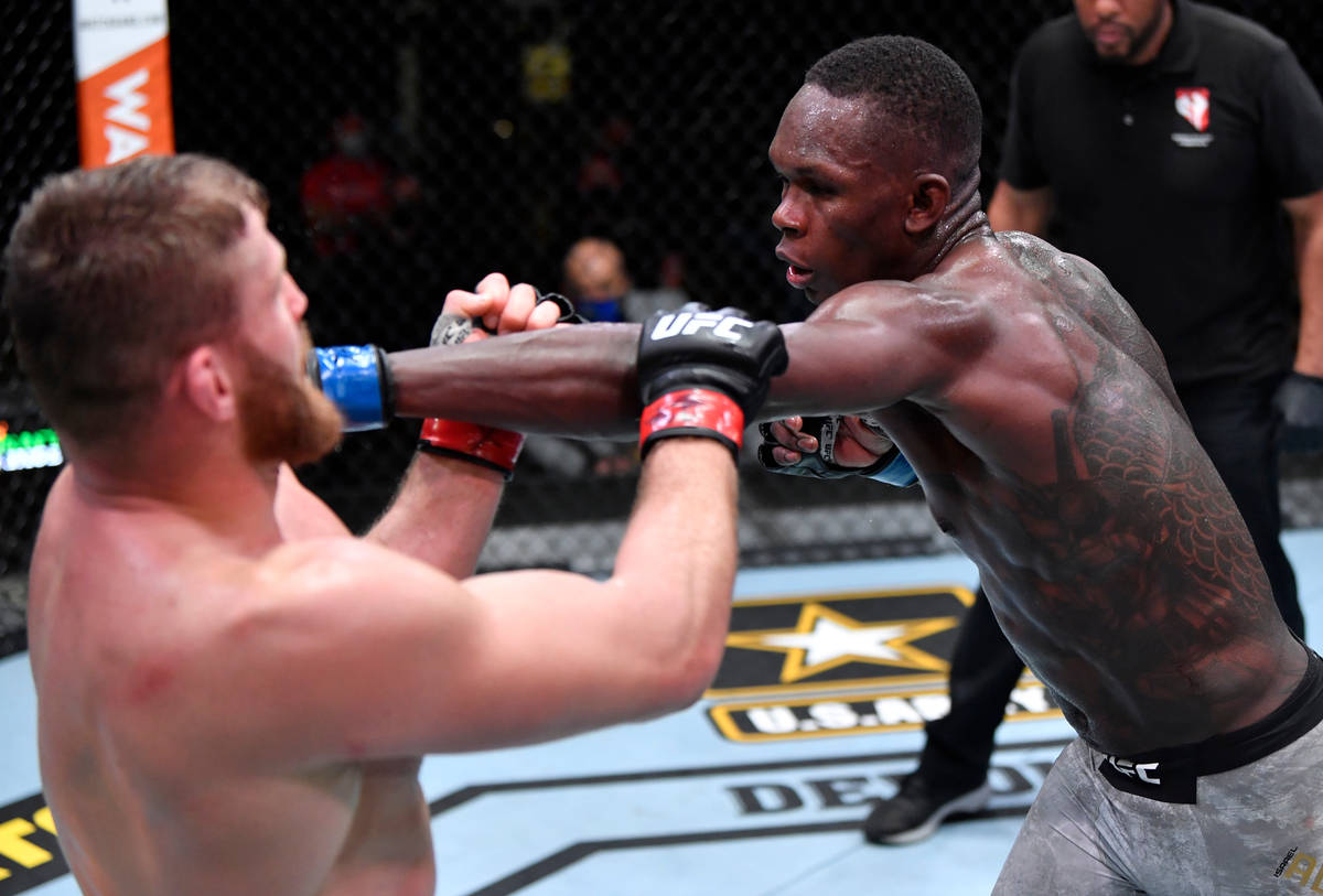 LAS VEGAS, NEVADA - MARCH 06: (R-L) Israel Adesanya of Nigeria punches Jan Blachowicz of Poland ...