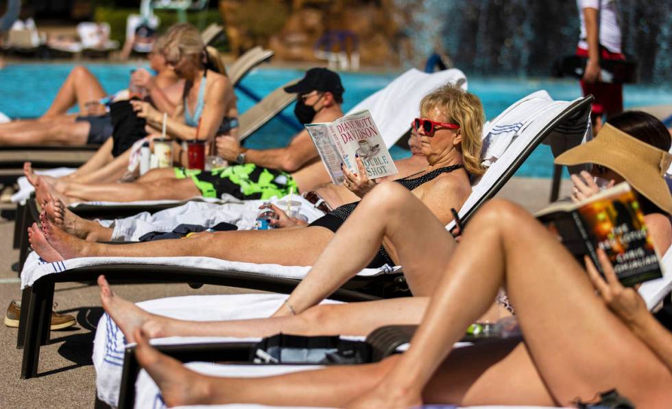 Guests lounge by the pool at The Mirage on Saturday, March 6, 2021, in Las Vegas. (Benjamin Hag ...