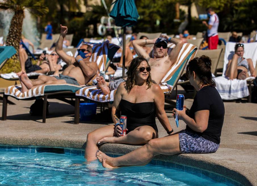 Kenna Belloli, front/left, and Mindy Starry, from Twin Falls, Idaho, talk by the pool at The Mi ...