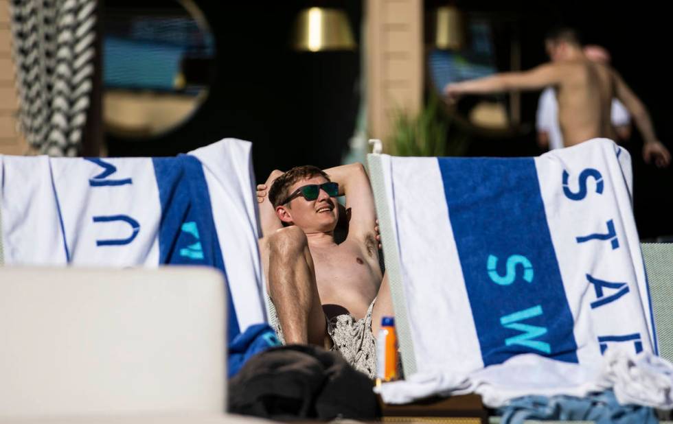 Guests lounge by the pool at Stadium Swim at Circa resort on Friday, March 5, 2021, in Las Vega ...