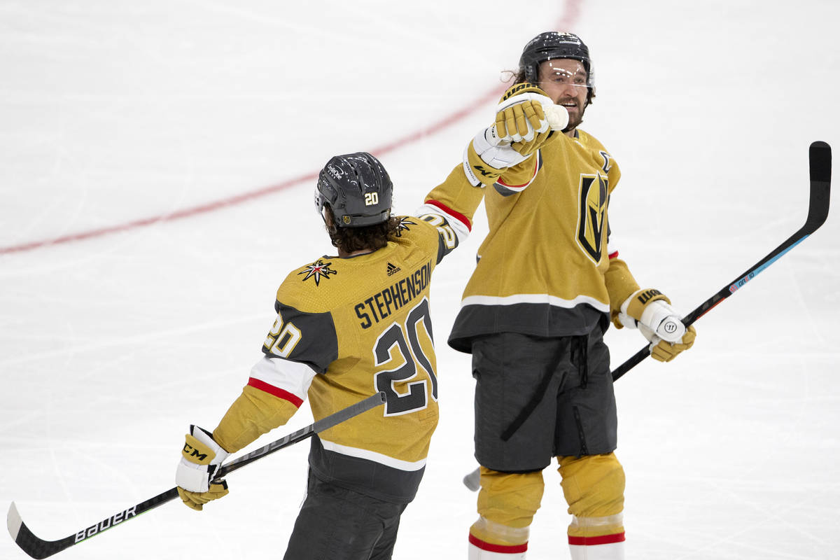 Golden Knights right wing Mark Stone (61) celebrates scoring a goal with Golden Knights center ...