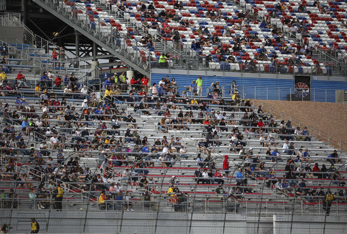 Fans watch the action during the NASCAR Cup Series Pennzoil 400 auto race at the Las Vegas Moto ...