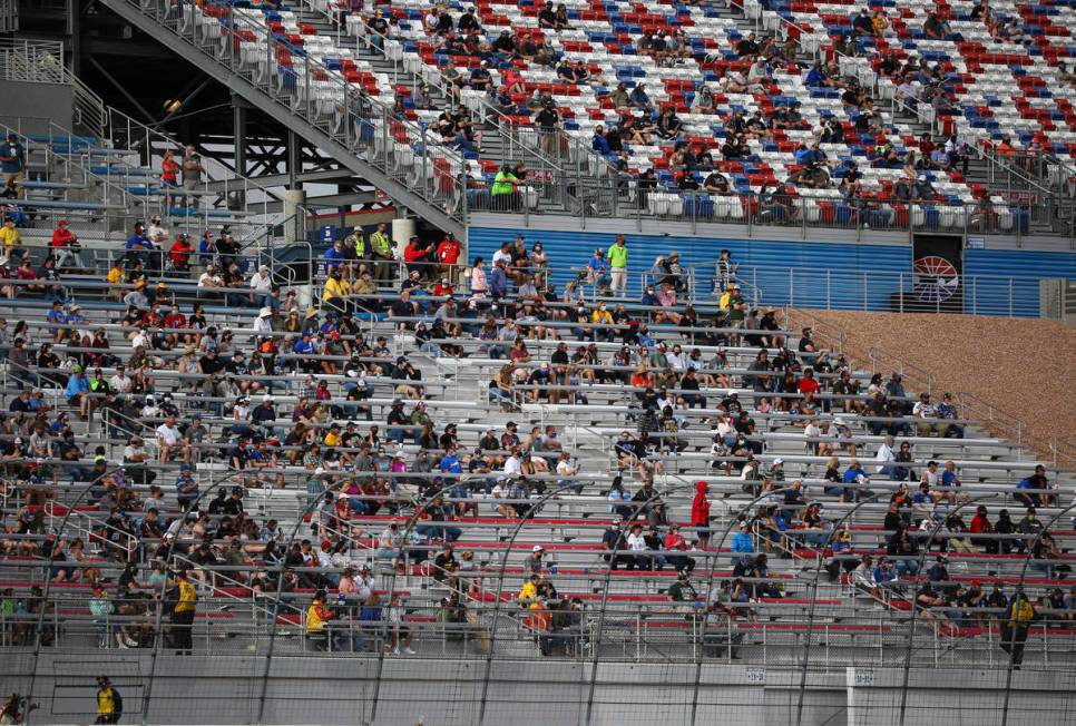 Fans watch the action during the NASCAR Cup Series Pennzoil 400 auto race at the Las Vegas Moto ...