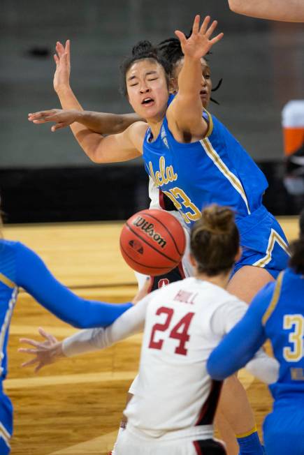 UCLA Bruins guard Natalie Chou (23) and Stanford Cardinal guard Kiana Williams (23) fall after ...