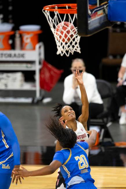 Stanford Cardinal guard Kiana Williams (23) shoots a point while UCLA Bruins guard Charisma Osb ...