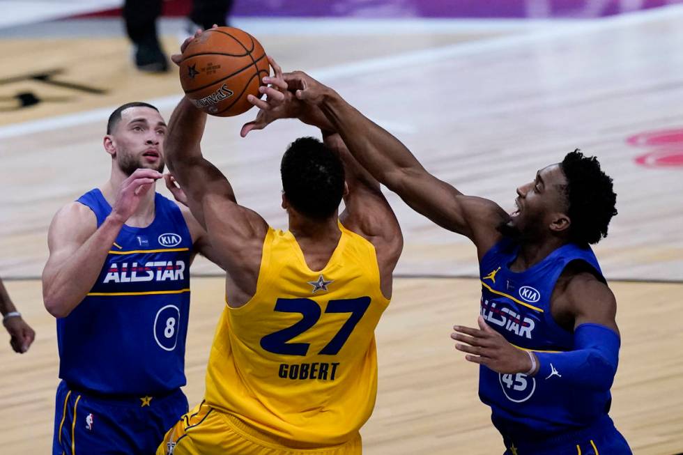 Utah Jazz guard Donovan Mitchell blocks a shot by Utah Jazz center Rudy Gobert during the secon ...