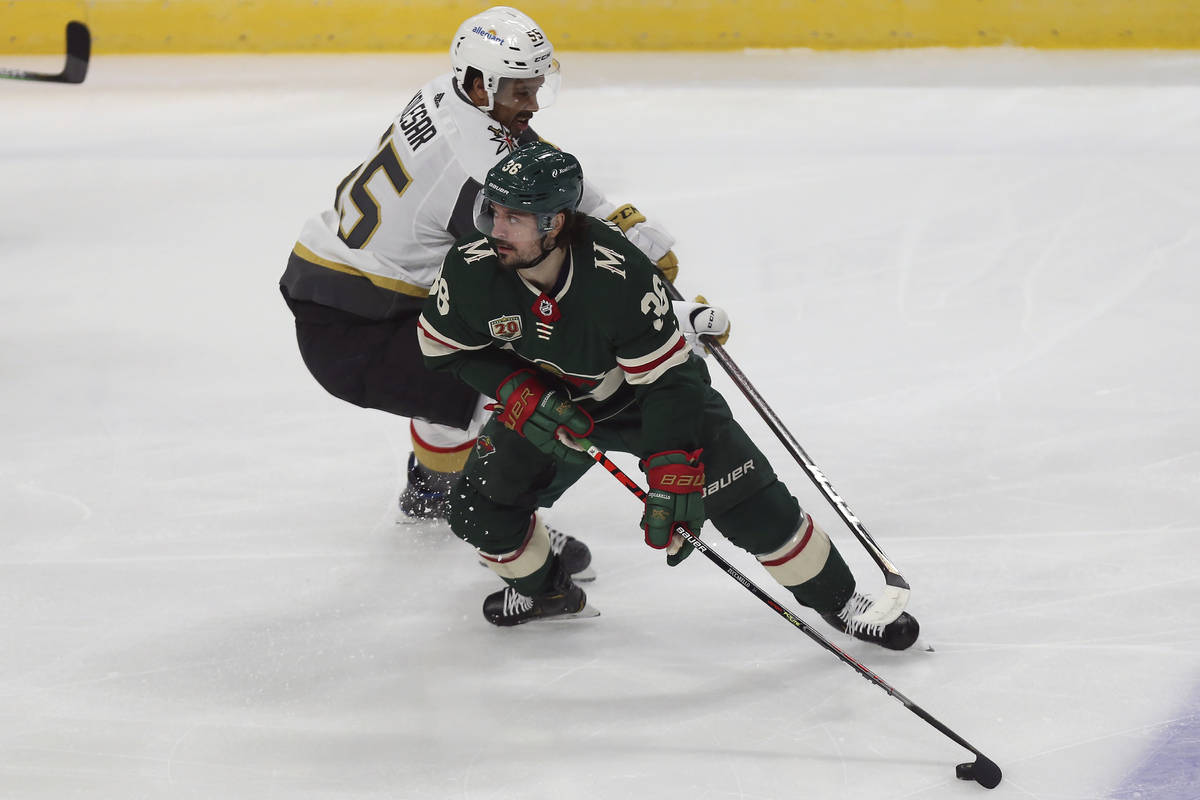 Minnesota Wild's Mats Zuccarello (36) sneaks the puck away from Vegas Golden Knights' Keegan Ko ...