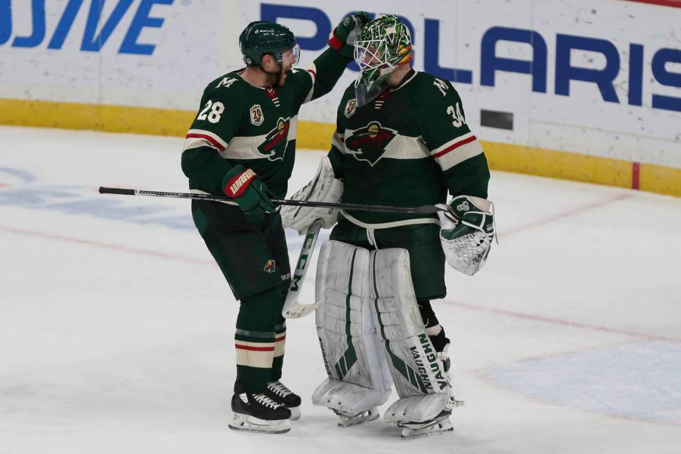 Minnesota Wild's Ian Cole (28) celebrates with goalie Kaapo Kahkonen (34) after their win over ...