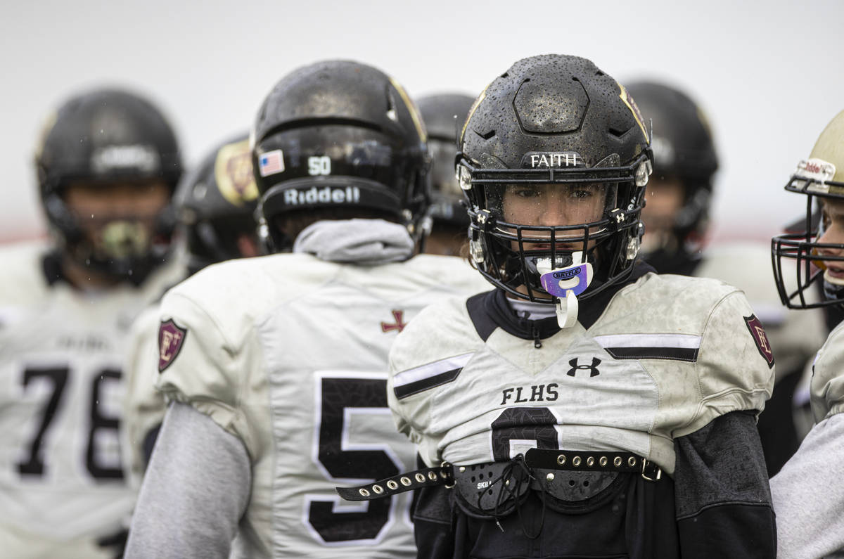 Faith Lutheran football players warm up before the start of practice on Thursday, March 11, 202 ...