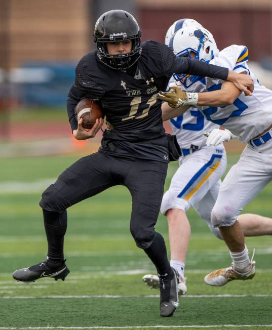 Faith LutheranÕs Adam Babb (11) attempts to break a tackle from Moapa ValleyÕs Jayme ...