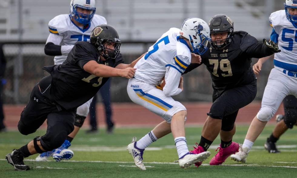 Moapa ValleyÕs QB Cameron Reese (5) is sacked by Faith LutheranÕs defensemen during t ...