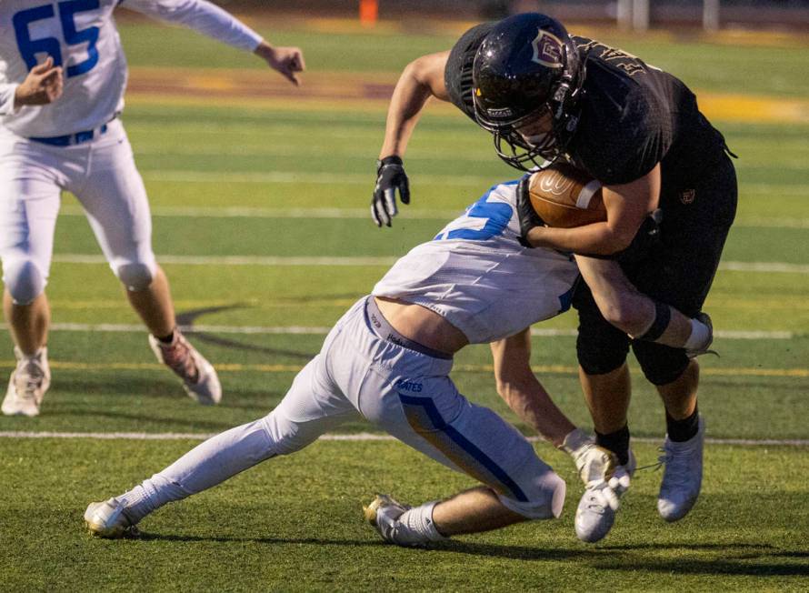 Faith LutheranÕs Marcos Canales (9) is tackled by Moapa ValleyÕs Jayme Carvajal (25) ...