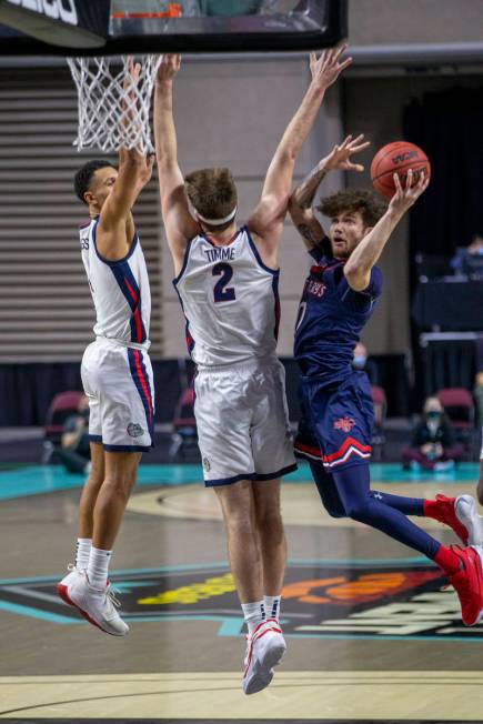 A shot attempt by St. Mary's Gaels guard Logan Johnson (0) is defended by Gonzaga Bulldogs forw ...