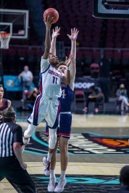 Gonzaga Bulldogs guard Joel Ayayi (11) leaps past St. Mary's Gaels forward Kyle Bowen (14) to m ...