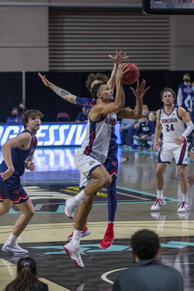 Gonzaga Bulldogs guard Jalen Suggs (1) shoots as St. Mary's Gaels guard Logan Johnson (0) looks ...