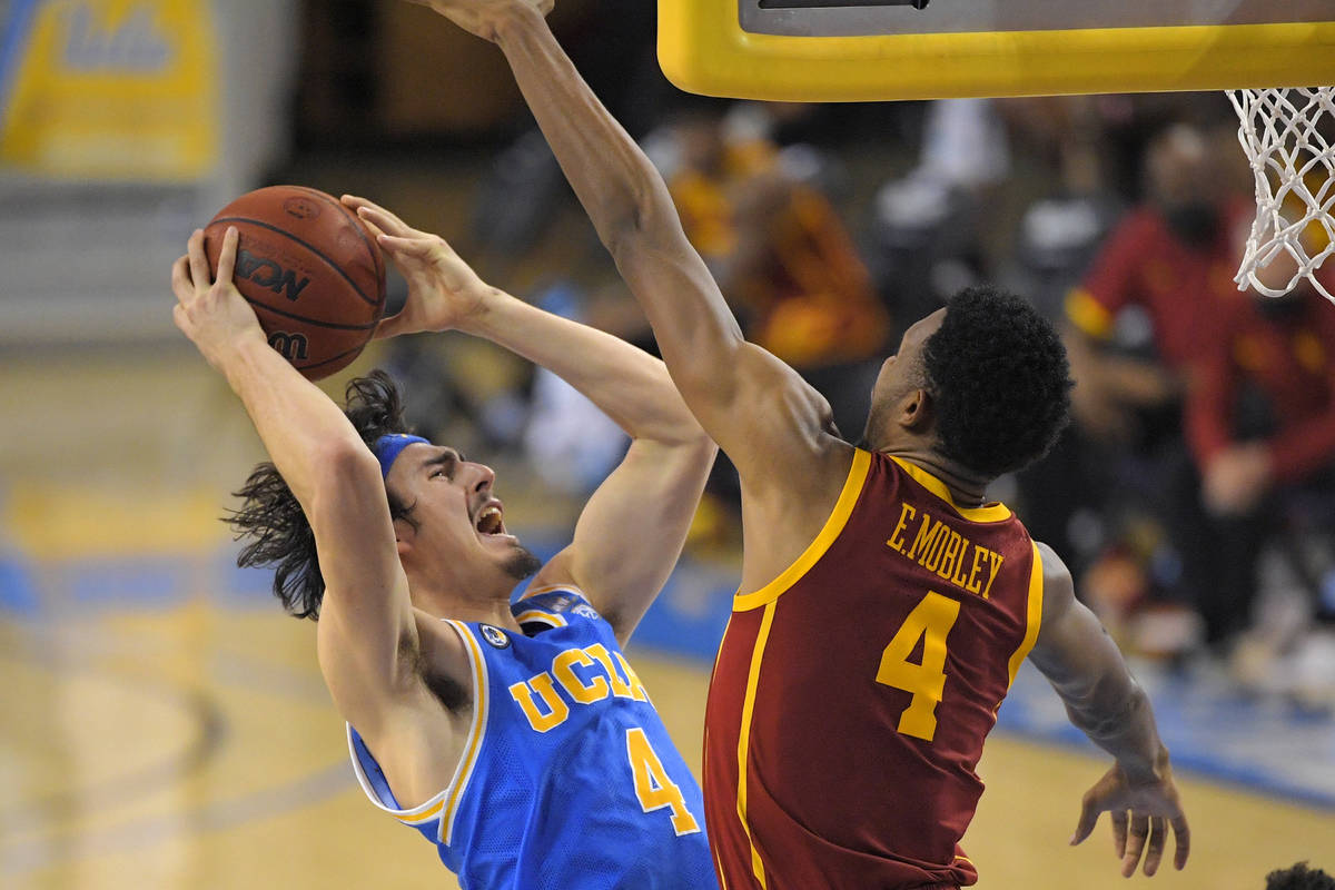 UCLA guard Jaime Jaquez Jr., left, shoots as Southern California forward Evan Mobley defends du ...