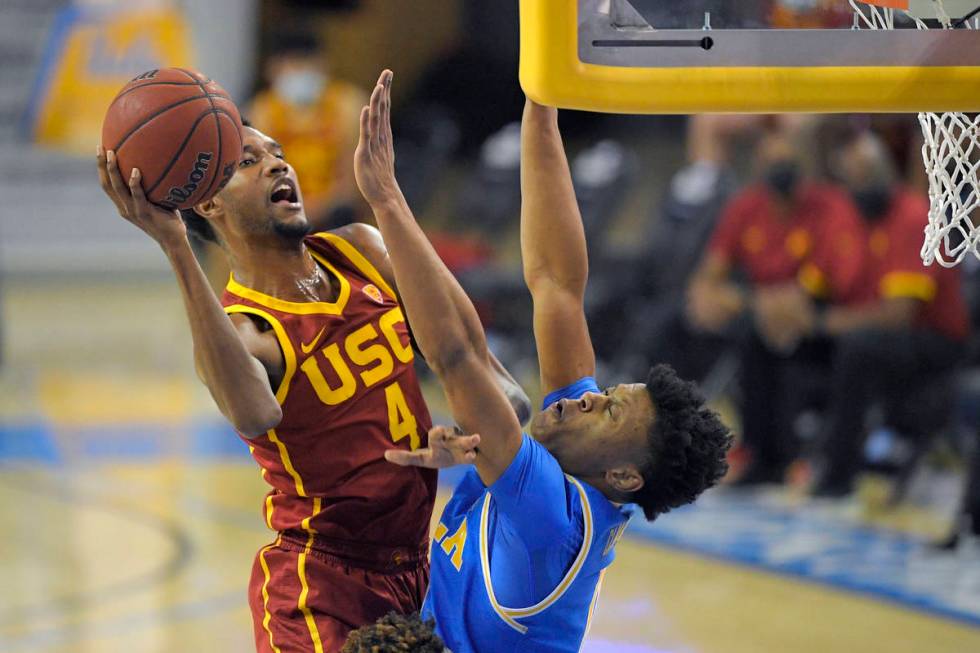 Southern California forward Evan Mobley, left, shoots as UCLA guard Jaylen Clark defends during ...